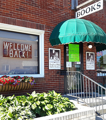 Beagle and Wolf Books with Welcome Back! sign