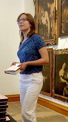 Amy Thielen speaking in front of paintings