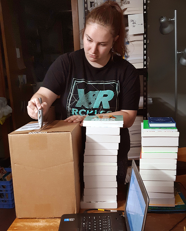 Megan opening a box of books